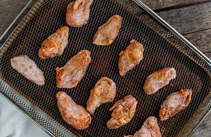 Air Fryer Chicken Wings that have been seasoned and placed on the Air Fryer Basket.