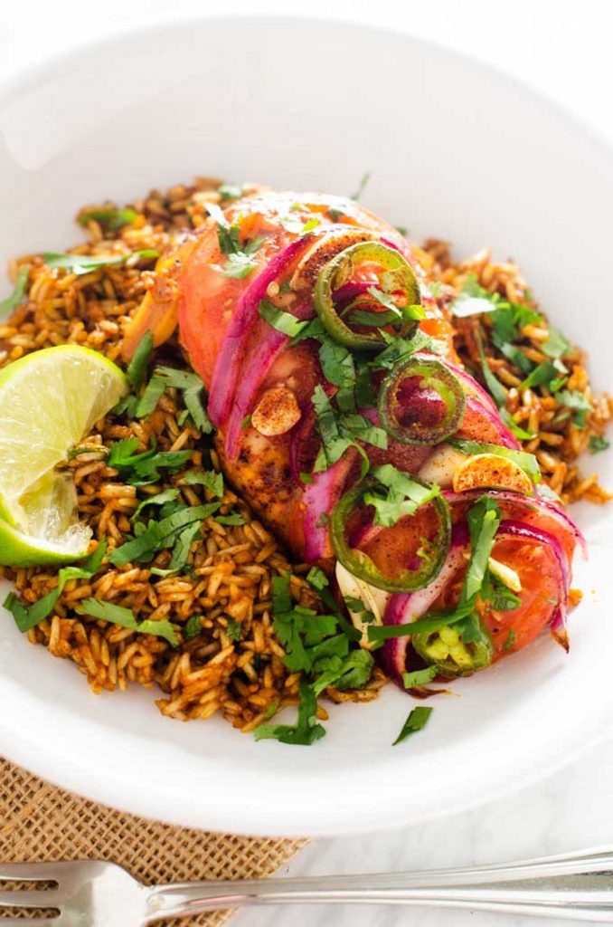 Photo of Southwest Baked Chicken on a bed of Spanish Brown Rice garnished with cilantro.