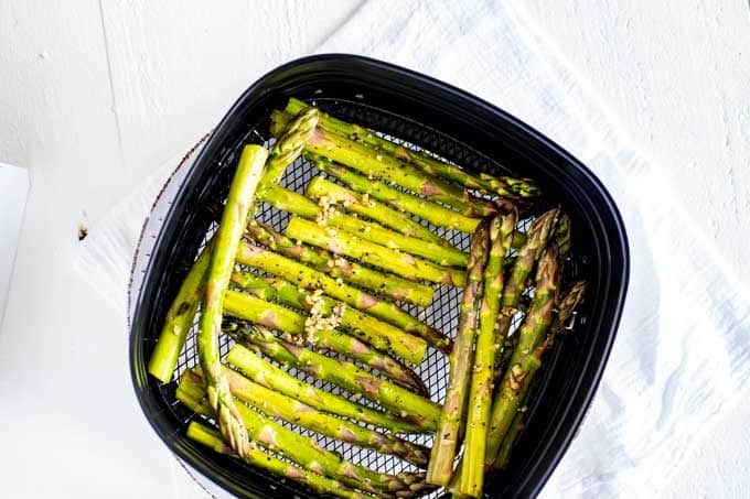 Photo of asparagus in an air fryer.