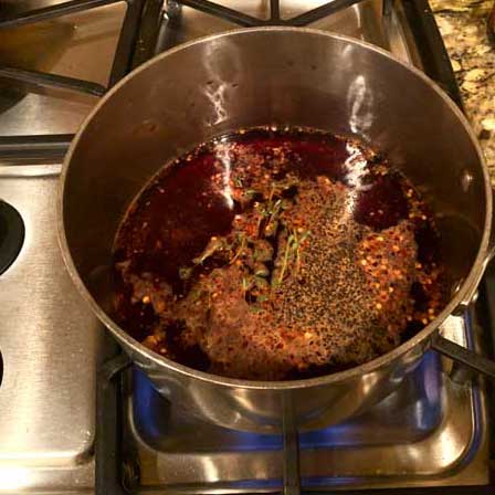 Photo of a saucepan with red wine and seasonings.