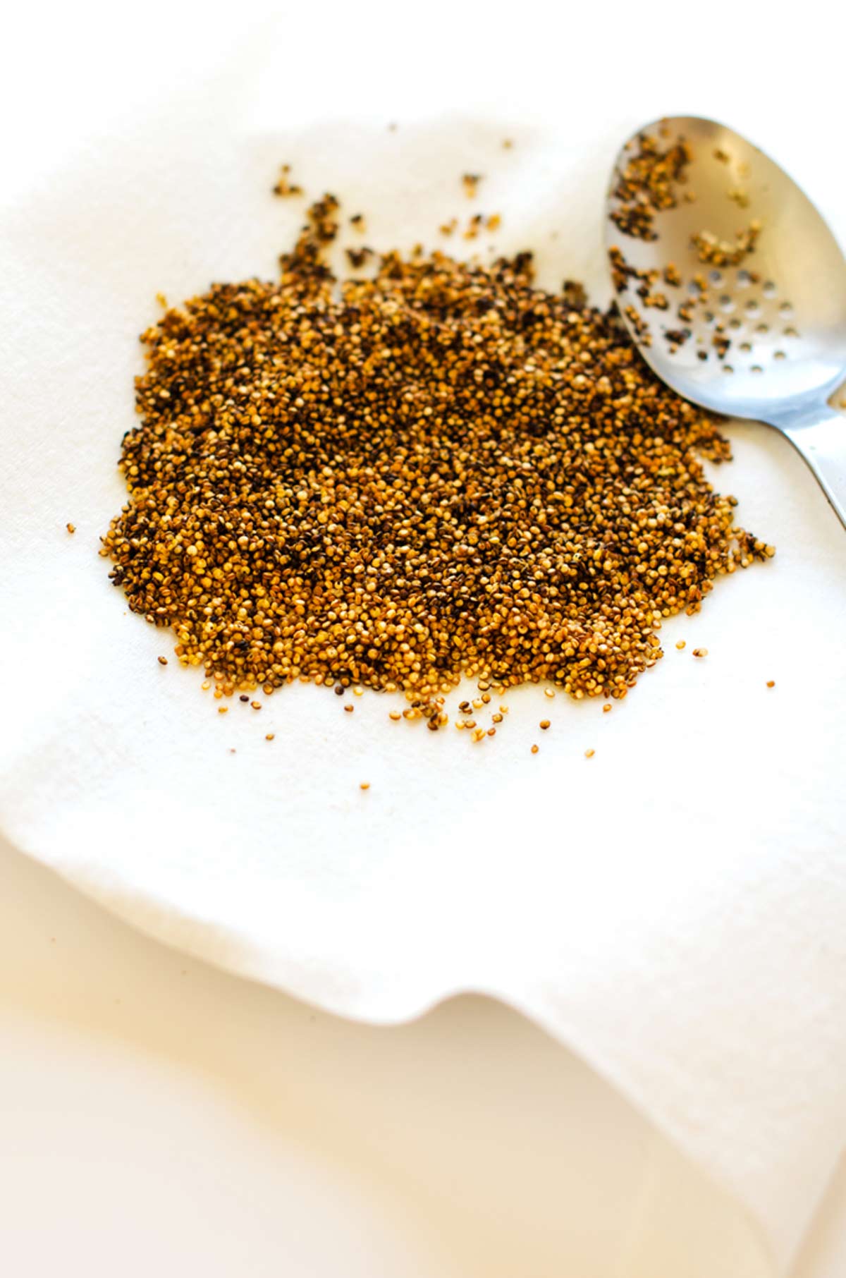 Photo of a paper towel lined plate with crispy quinoa on it.