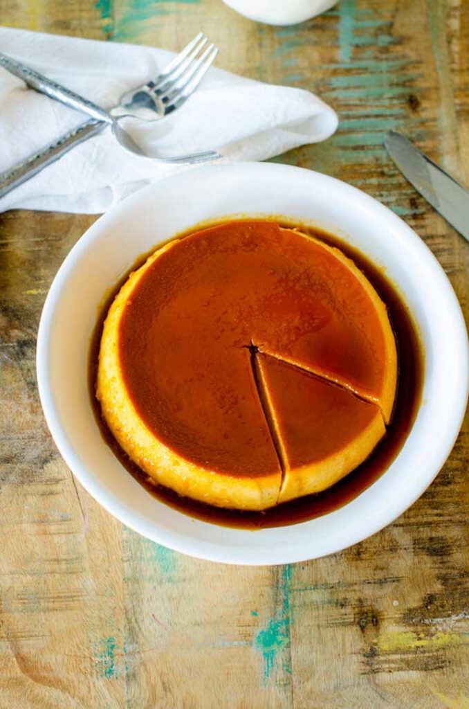 Photo of a white serving plate with pumpkin flan on it.