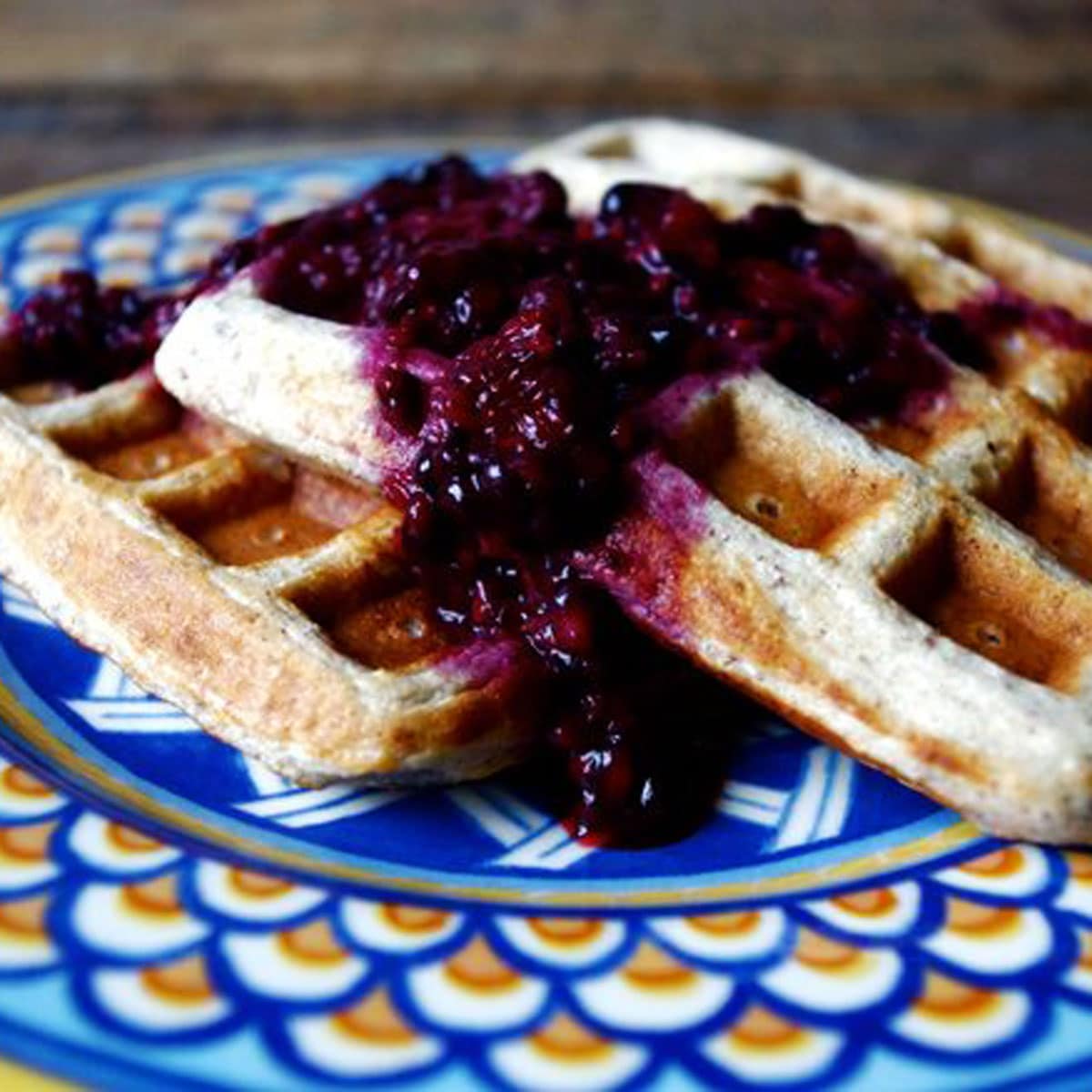 Square photo of quinoa waffles on a blue plate.