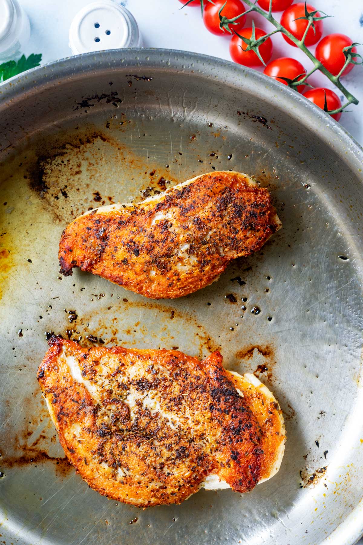 Photos of chicken being browned in a skillet.