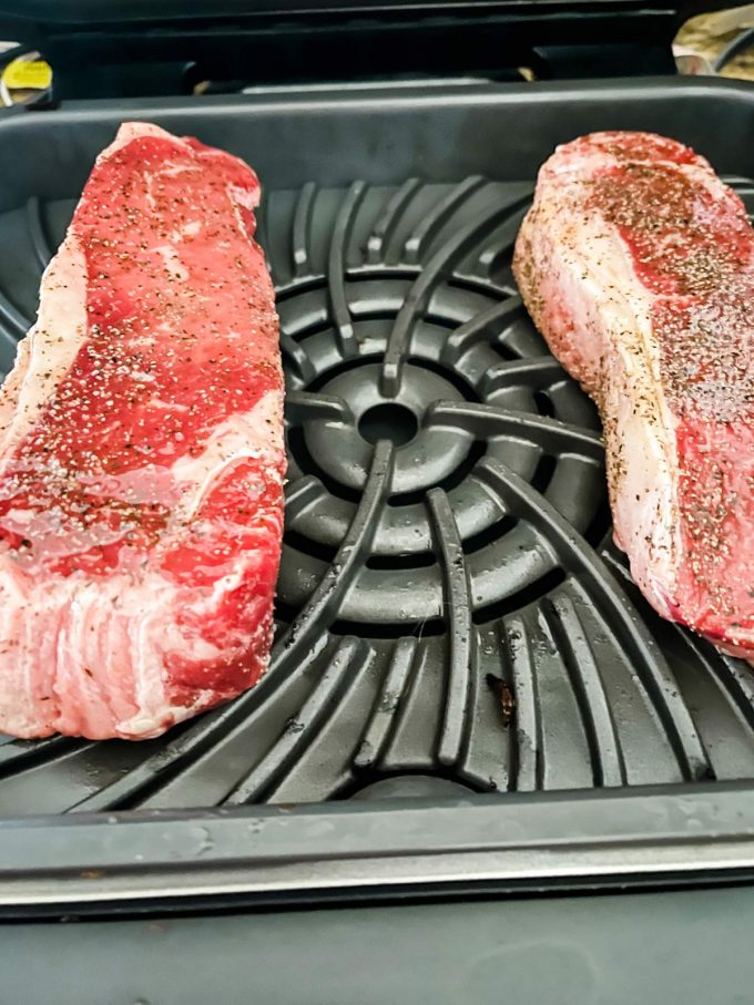 Photo of two steaks cooking on a Ninja Foodi Grill