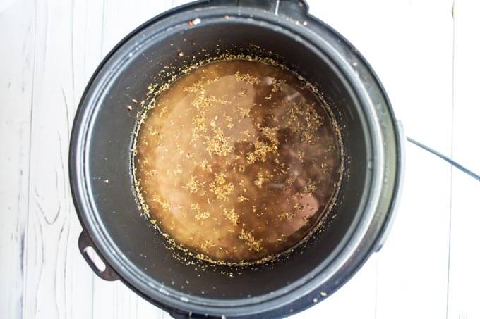 Quinoa, broth and seasonings in a rice cooker.