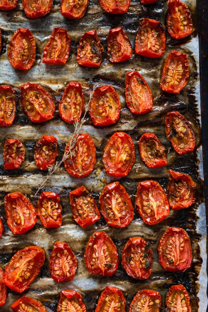 Photo of a baking sheet with roasted tomatoes.