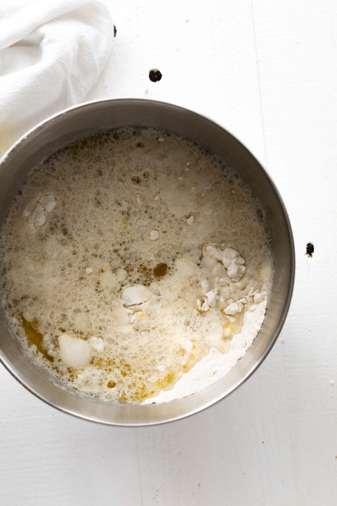 Photo of wet ingredients being added to dry ingredients for gluten free pizza crust.