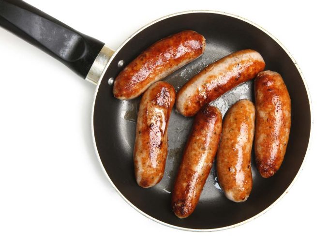Sausage cooking in a skillet.
