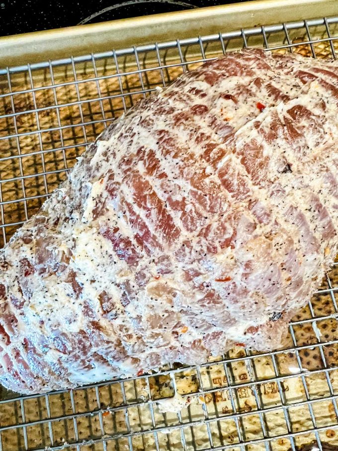 Photo of boneless turkey breast with butter rubbed all over it.