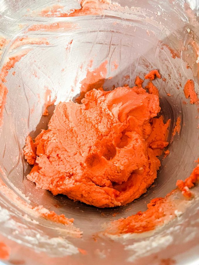 Photo of spritz cookie dough that has had red food coloring added to it.