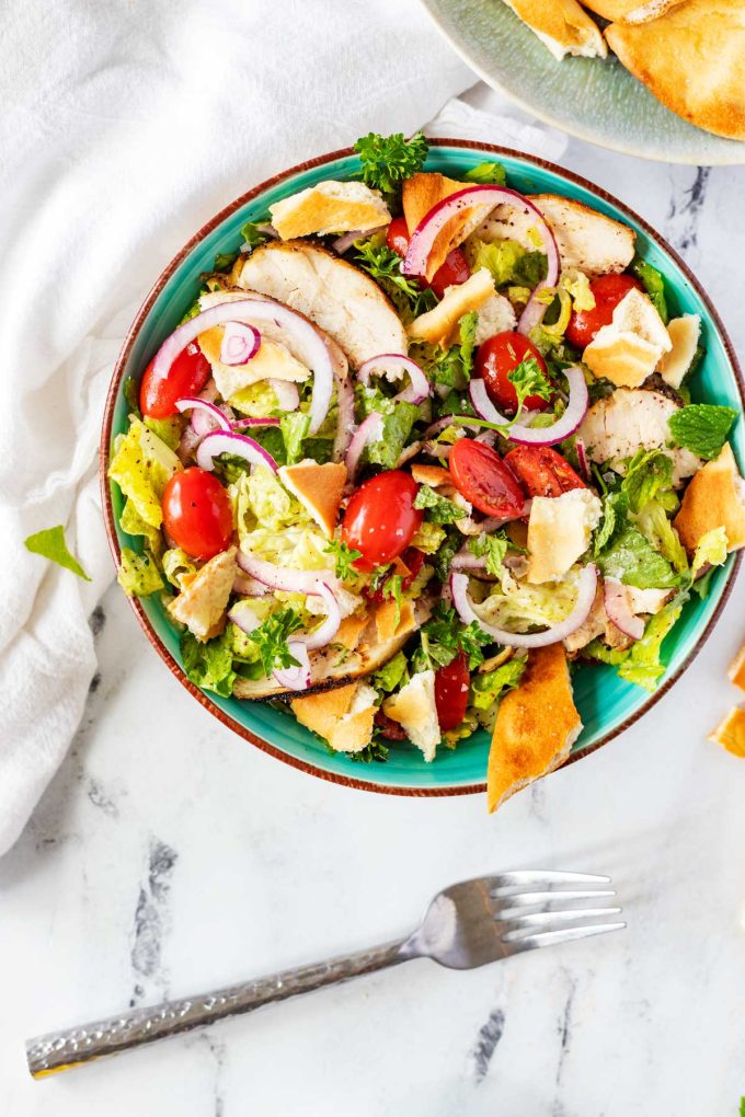 Overhead photo over a rustic bowl with Chicken Fattoush Salad.