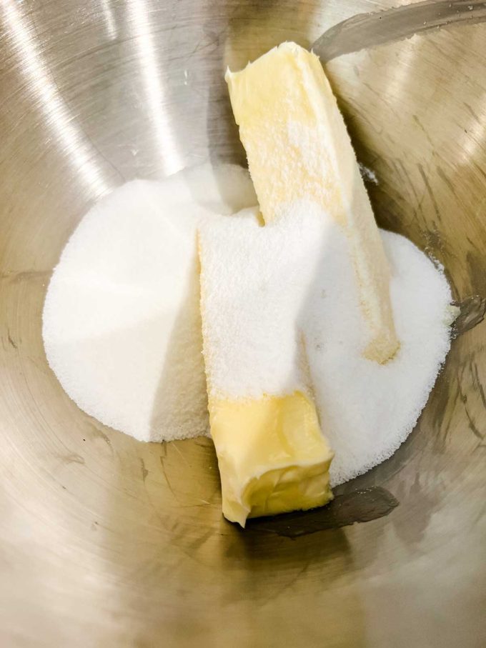 Photo of sugar and butter in the bowl of a stand mixer.