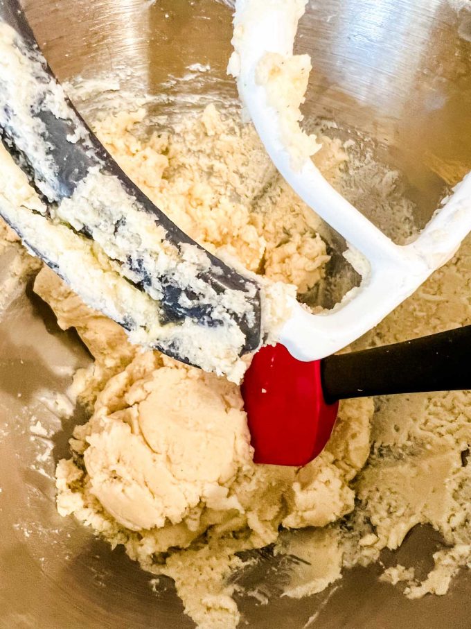 Photo of gluten free spritz cookie dough in the bowl of a stand mixer.