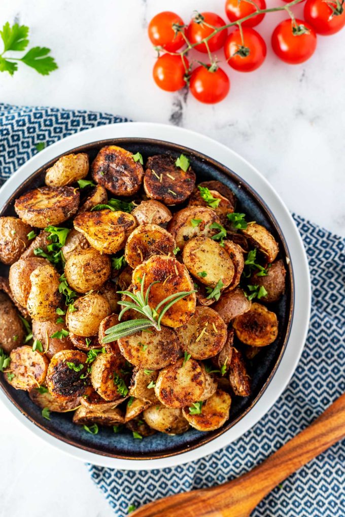 Overhead photo of a bowl of Blackstone Potatoes garnished with parsley.