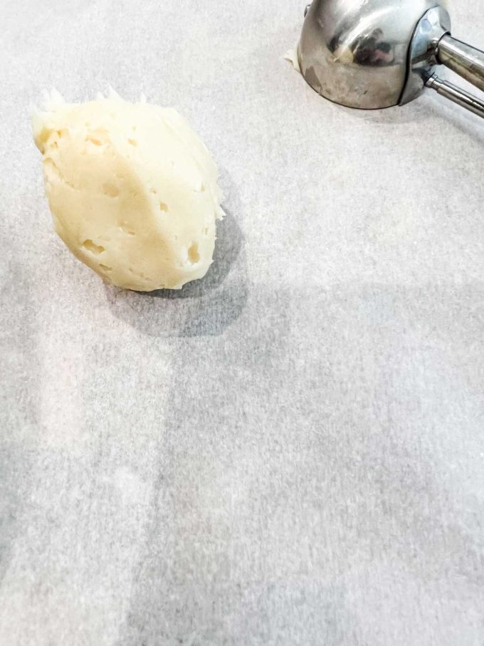 Photo of white chocolate that has been scooped out to make strawberry truffles.