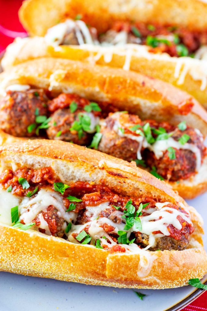 Close up photo of a platter of meatball subs.