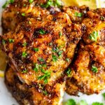 Close up square photo of air fryer chicken thighs.