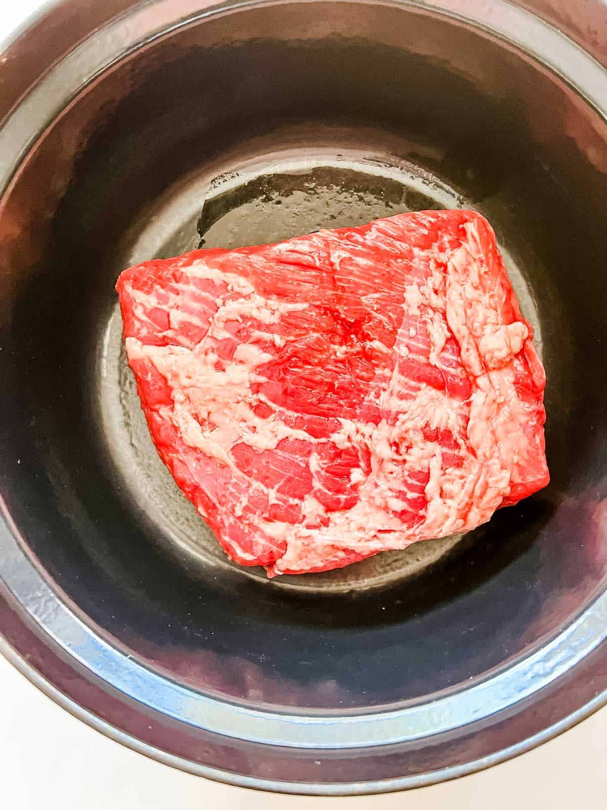 Photo of corned beef in a dutch oven.