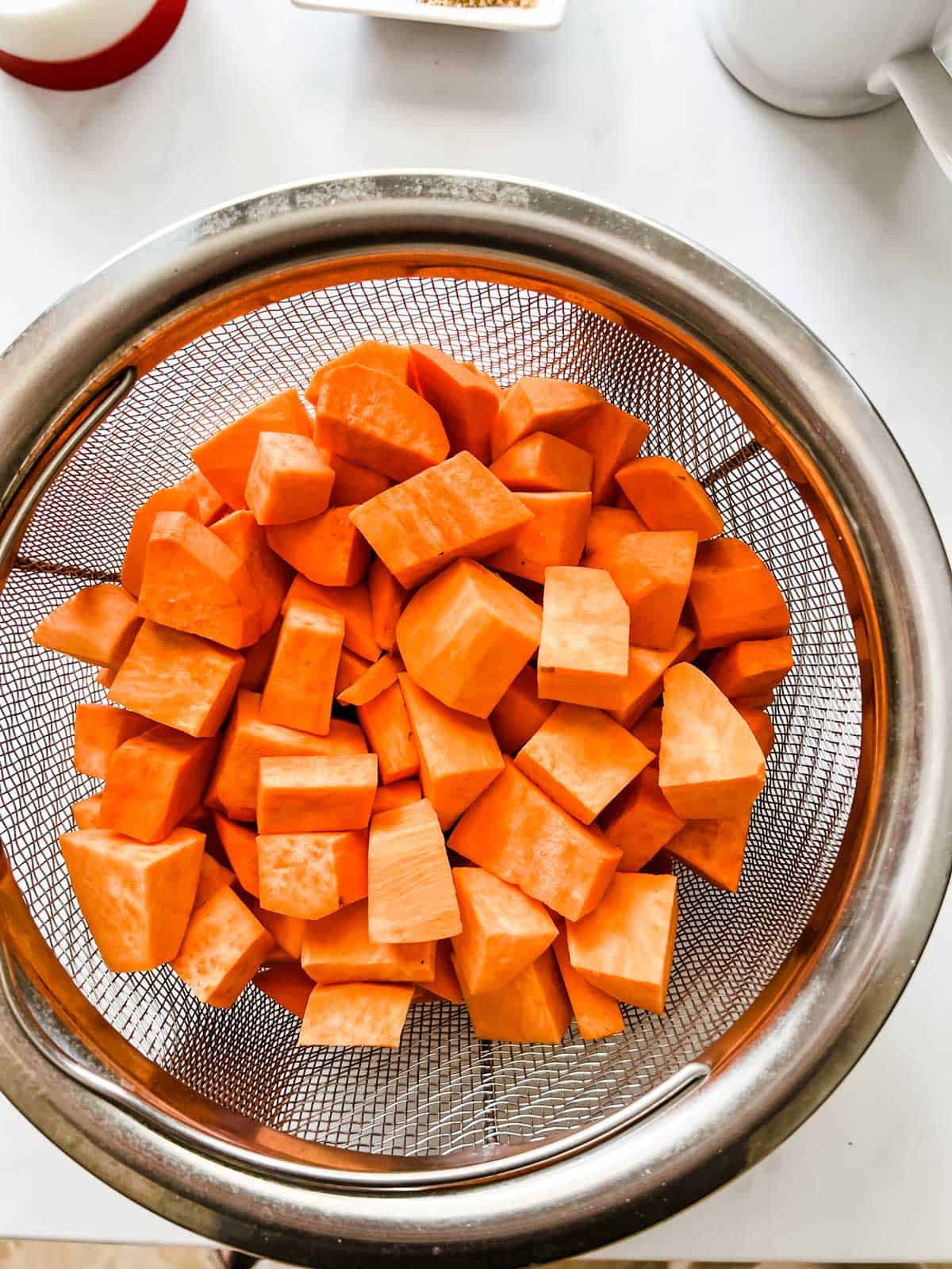 Cubed sweet potatoes in an Instant Pot steamer.