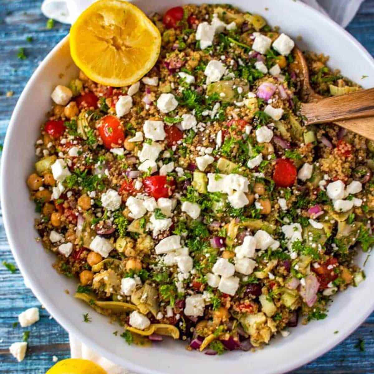 Square close up photo of a bowl of Mediterranean quinoa salad.