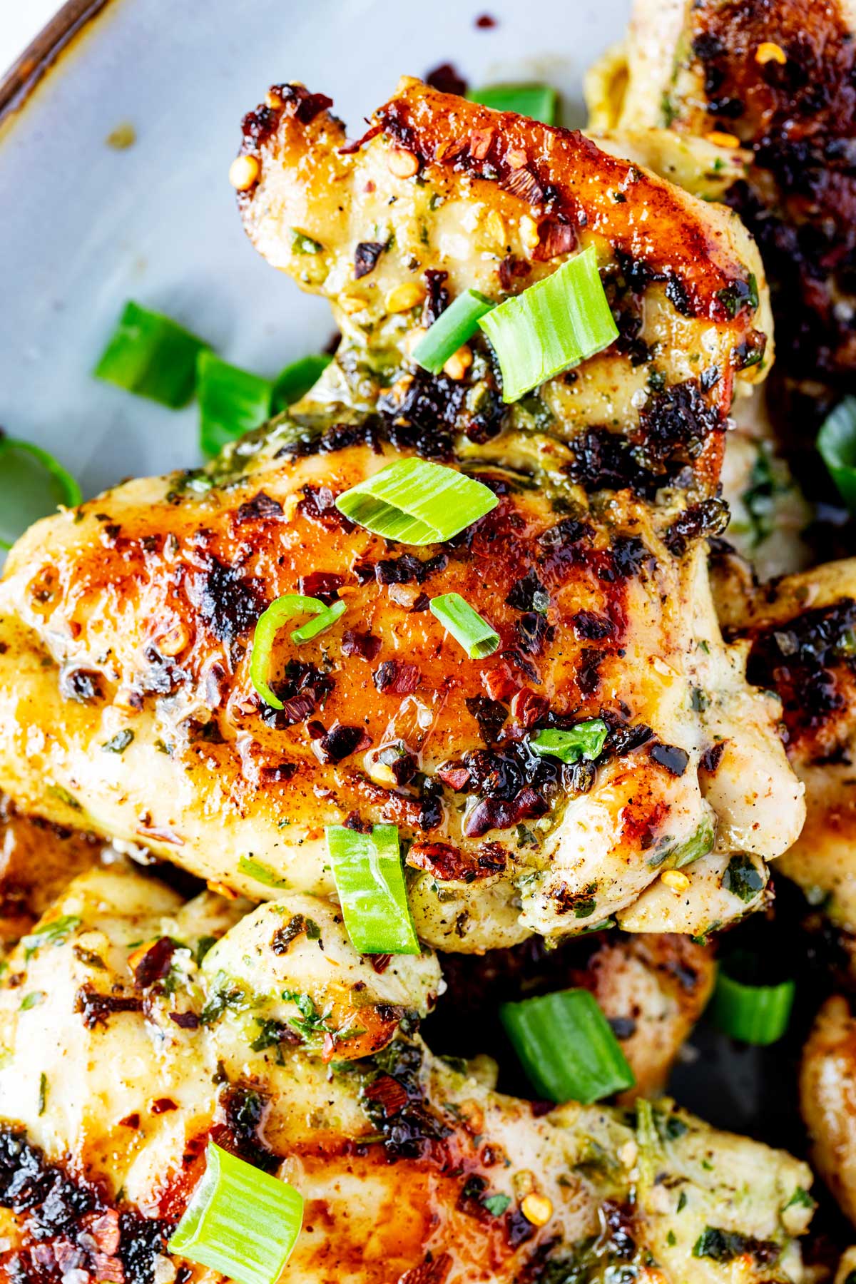 Close up photo of Blackstone Chicken thighs garnished with scallions.