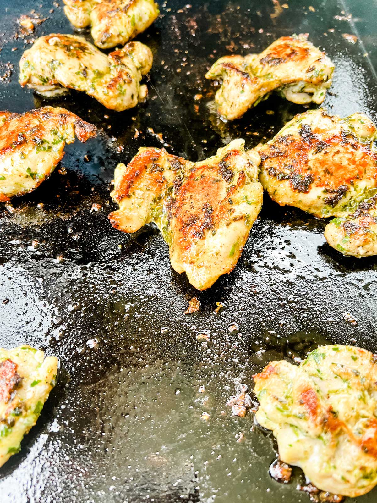 Photo of chicken thighs that are cooked on a Blackstone griddle.