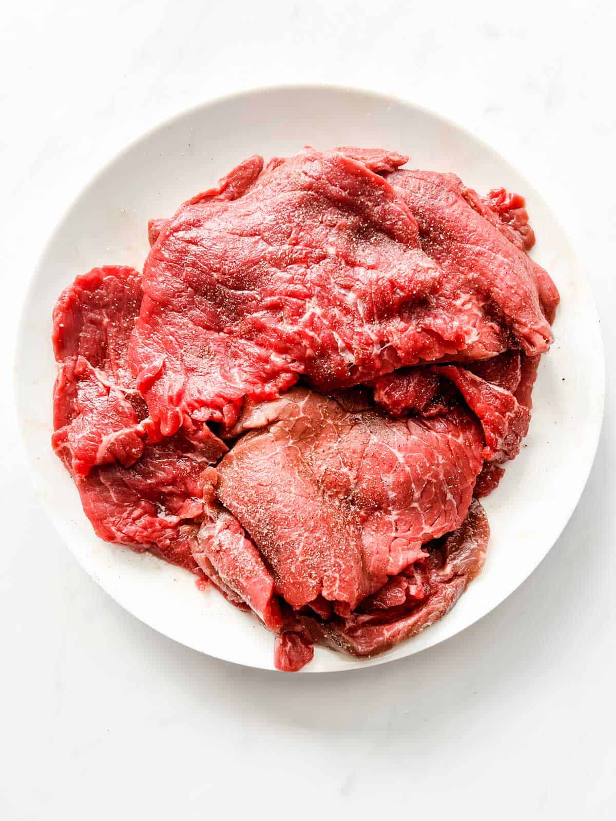 Thinly sliced steak seasoned with salt and pepper.