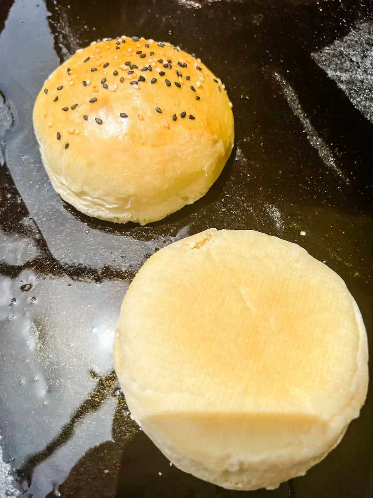 Photo of buns being toasted on a Blackstone griddle.