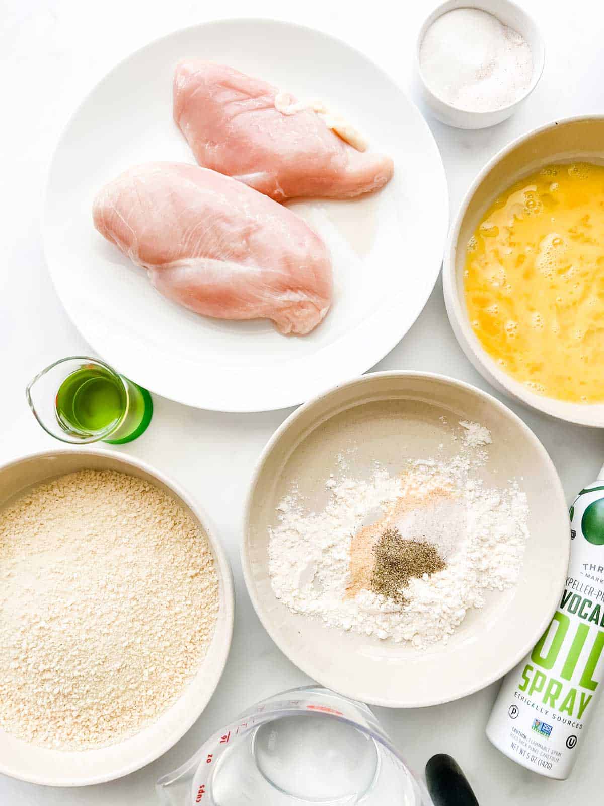 Photo of sugar, salt, chicken, oil, breadcrumbs, flour, seasonings, and eggs.