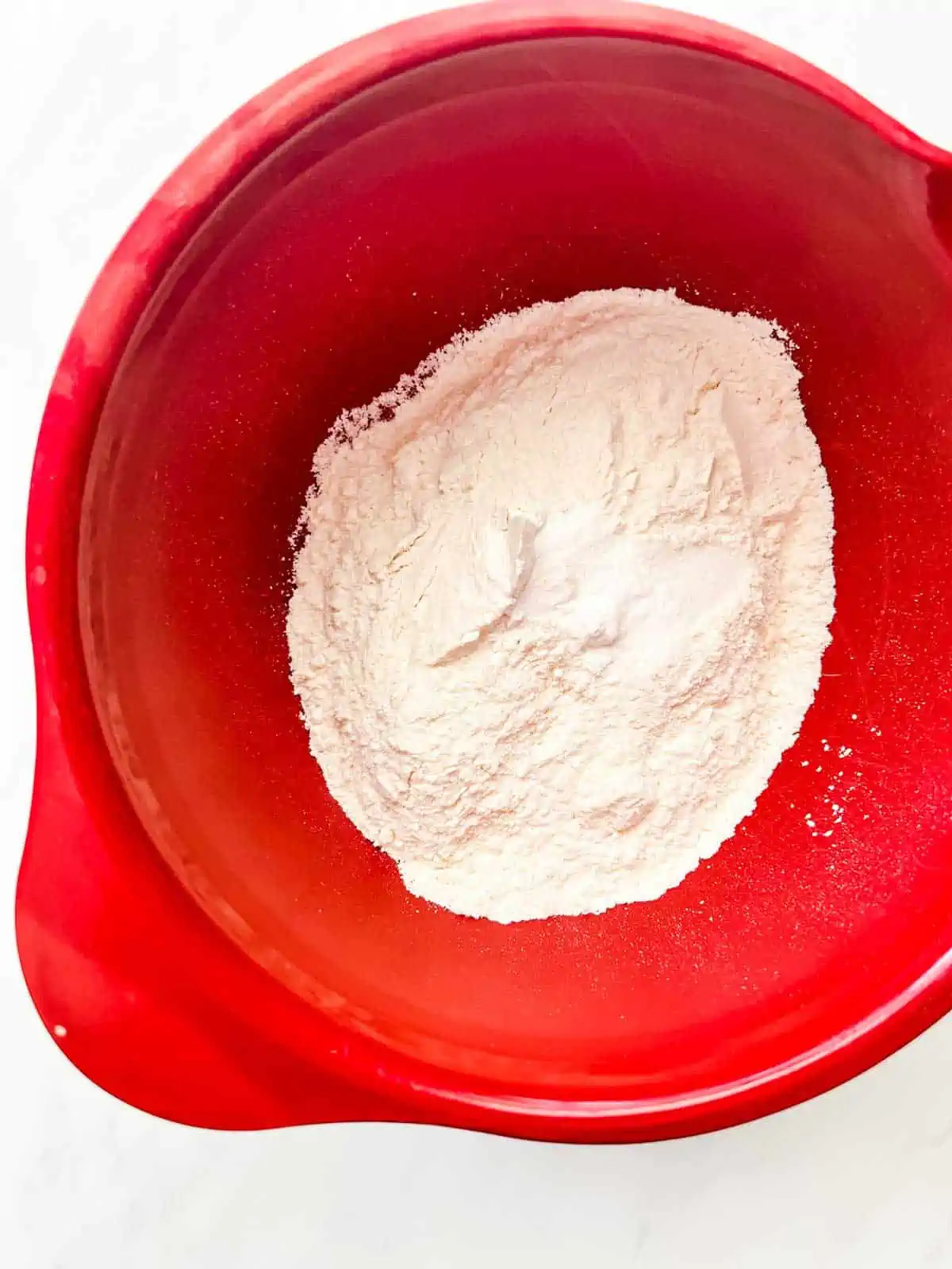 Flour, salt, and baking powder in a large red bowl.