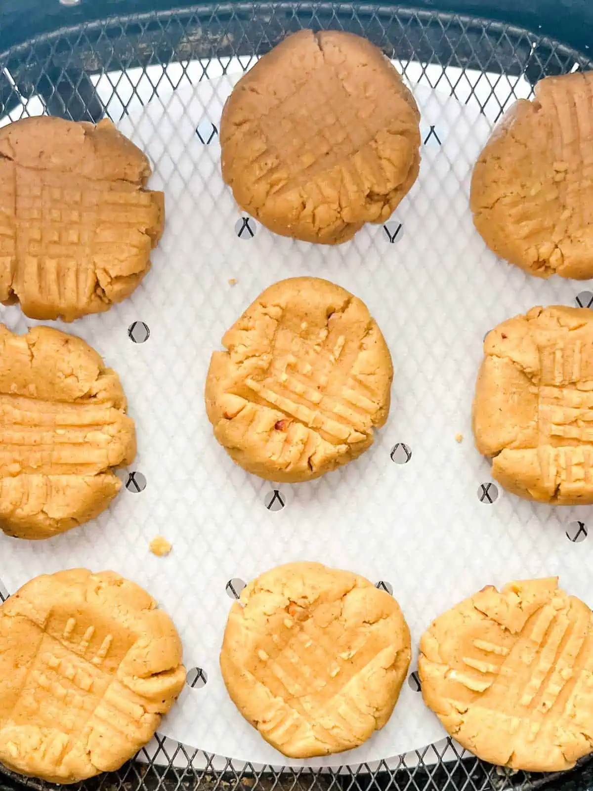 Overhead photo of peanut butter cookies in an air fryer.