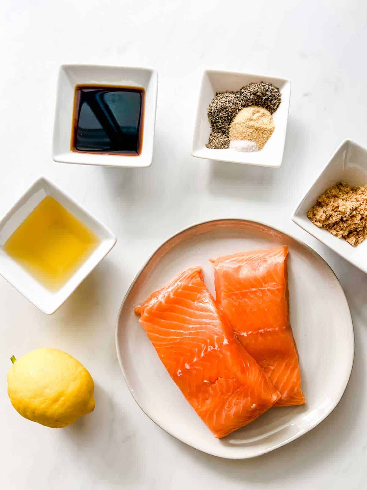 Overhead photo of ingredients for Blackstone Salmon: Salmon, soy sauce, oil, brown sugar, seasonings, and lemon juice.