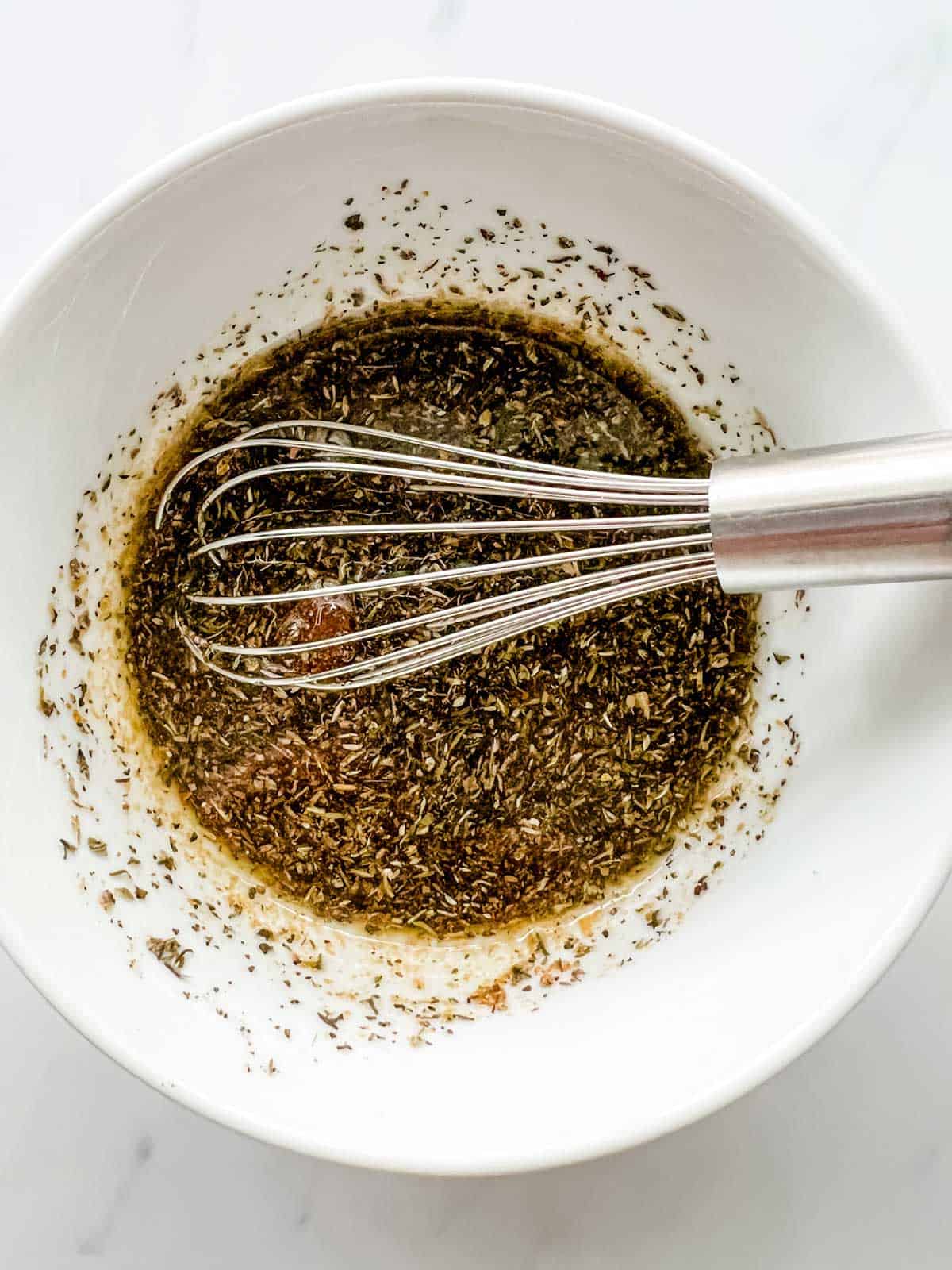 Photo of salmon marinade being whisked together in a bowl.