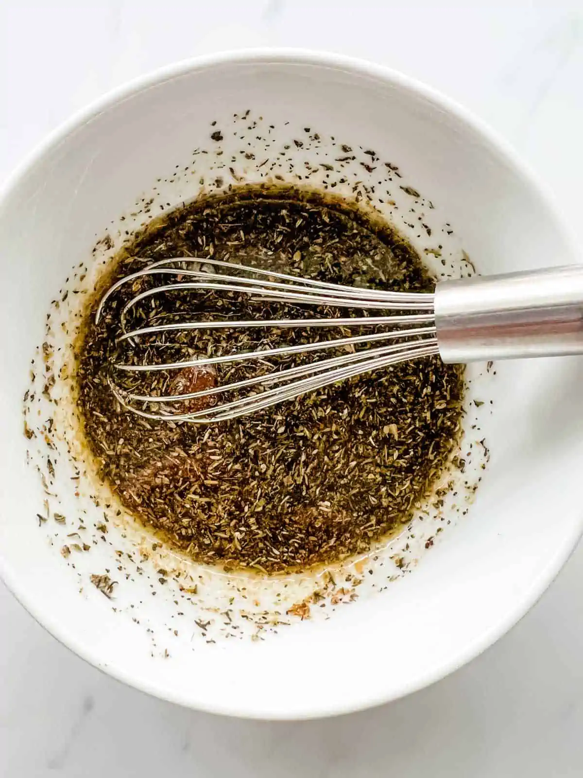 Photo of salmon marinade being whisked together in a bowl.