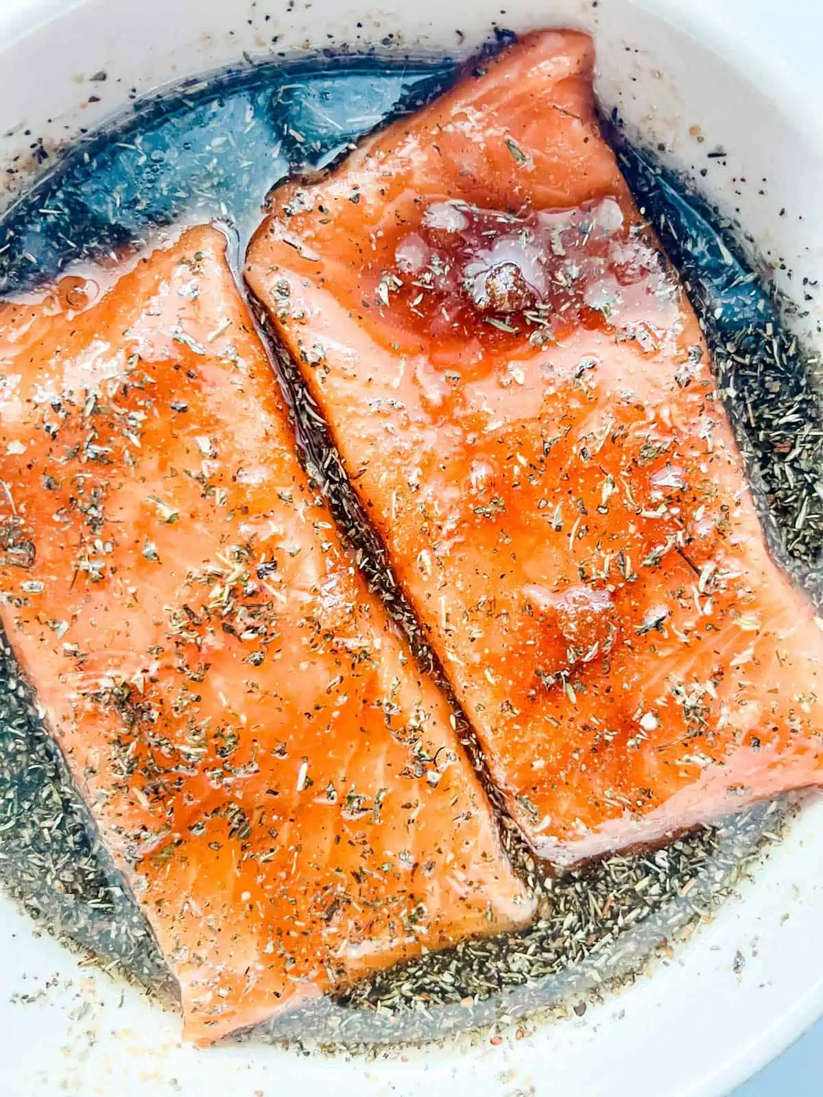 Photo of salmon marinating in a bowl.