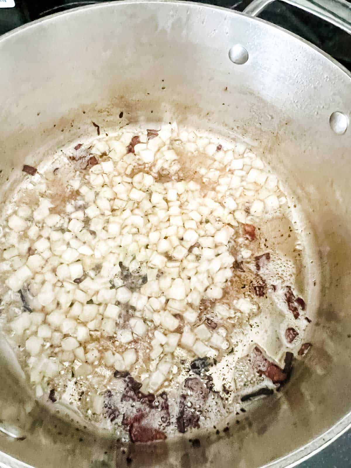 Photo of onion cooking in bacon grease.