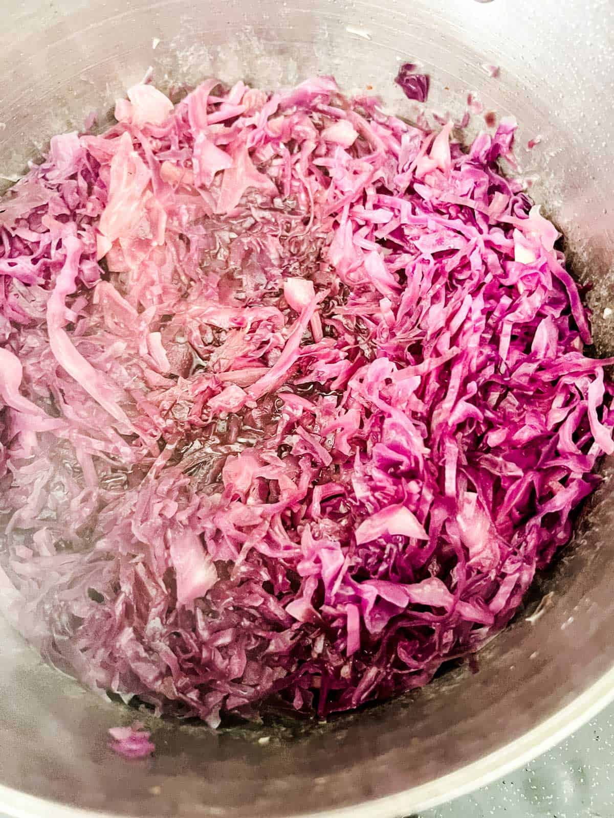 Photo of Braised red cabbage cooking in a dutch oven.