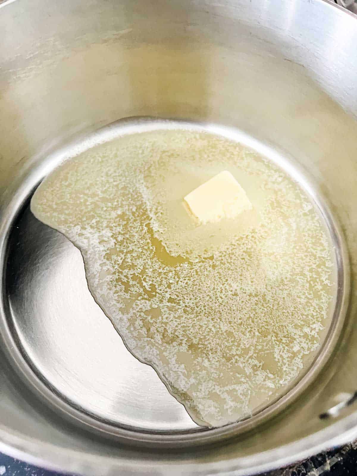 Photo of butter melted in a skillet.