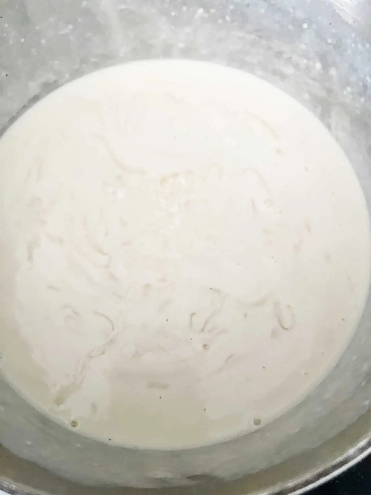 Photo of a cream sauce in a saucepan.