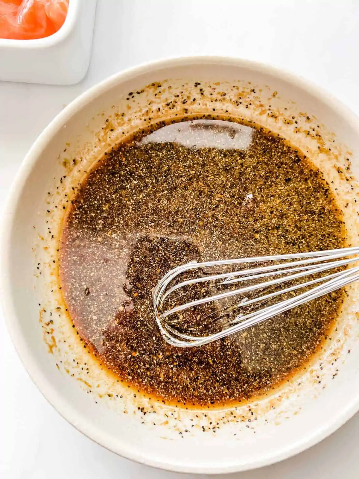 Photo of salmon marinade being whisked together in a small bowl.