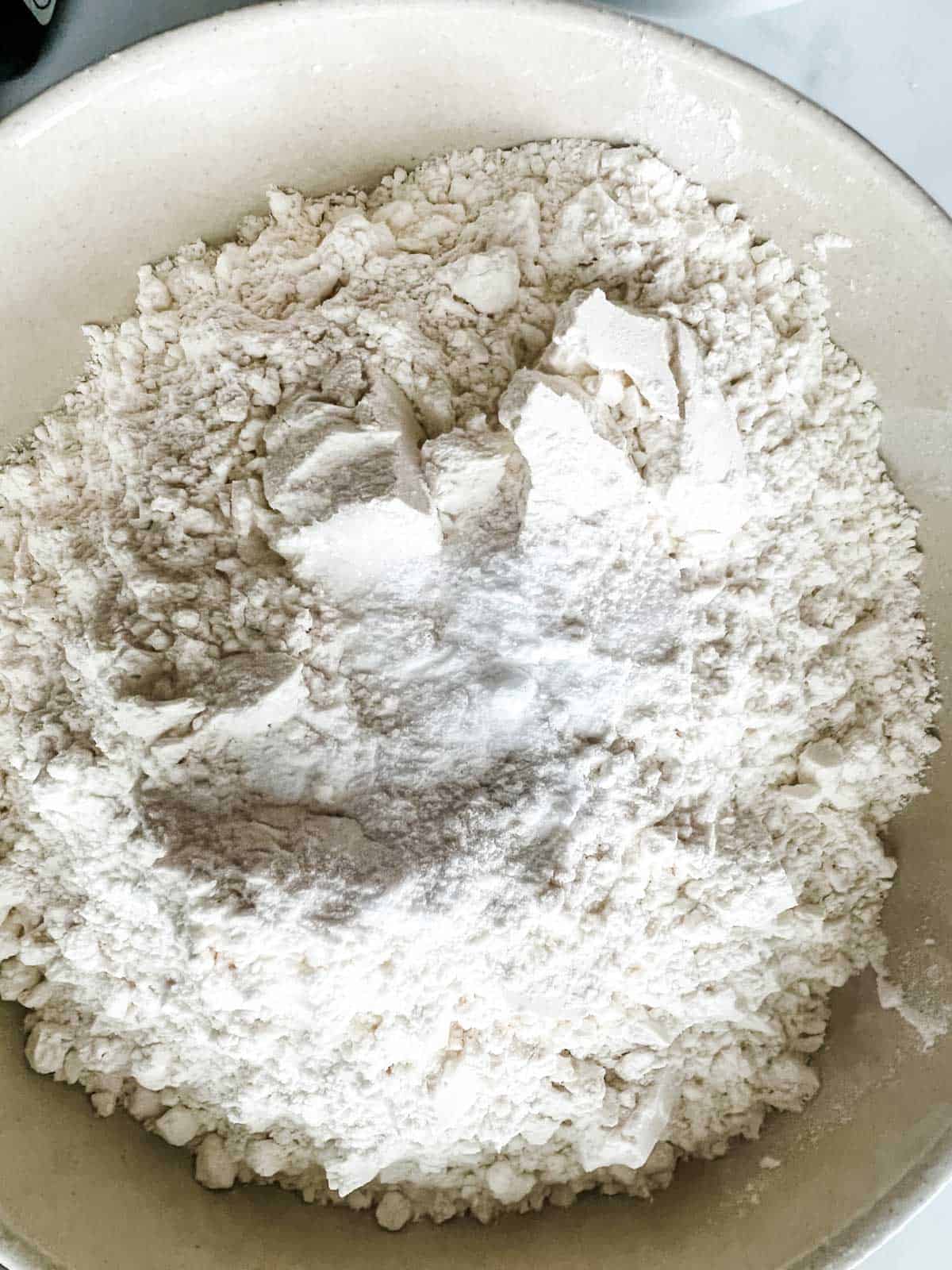 Photo of flour, salt, and baking powder in a bowl.