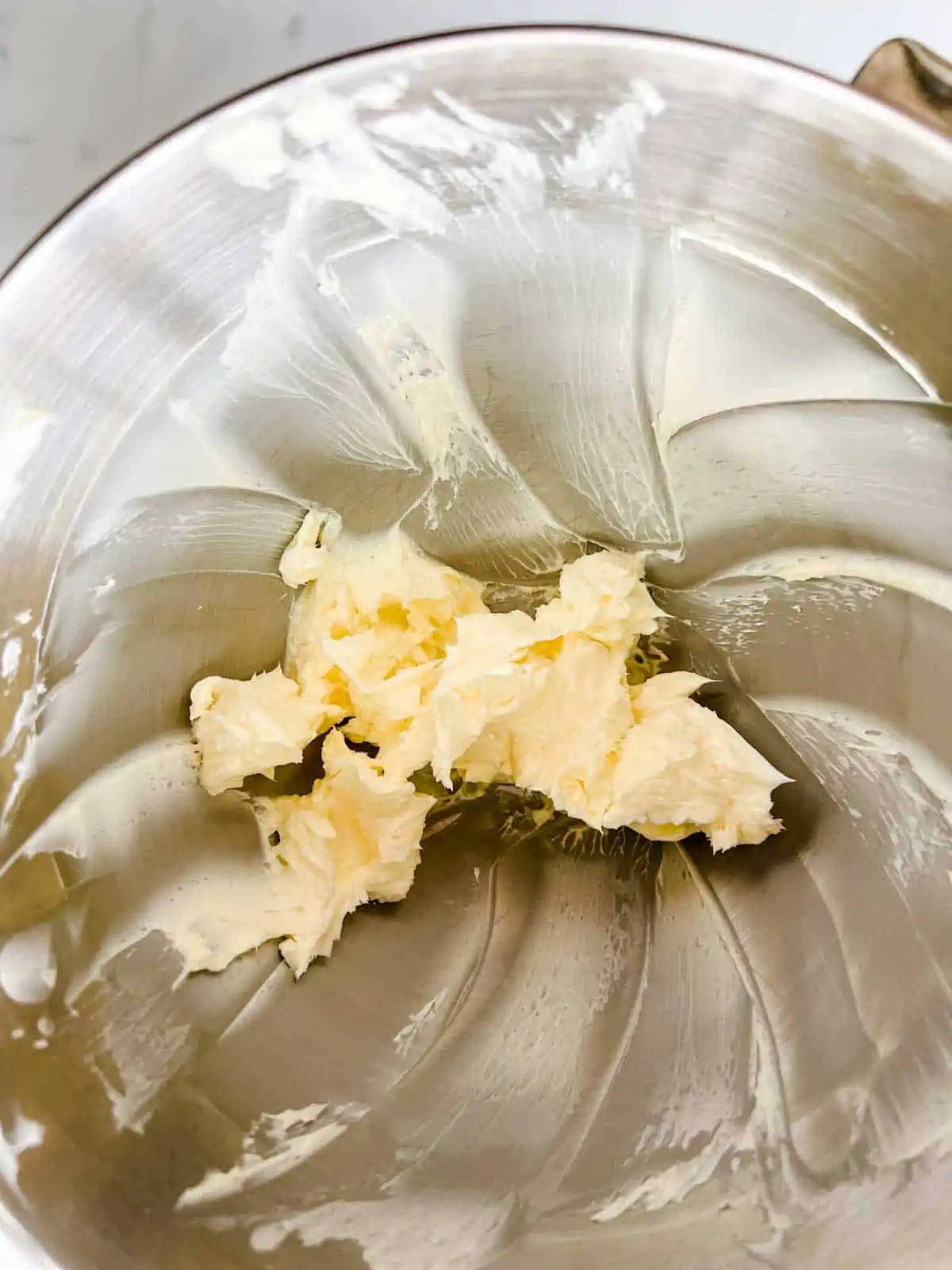 Photo of butter whipped in the bowl of a stand mixer.