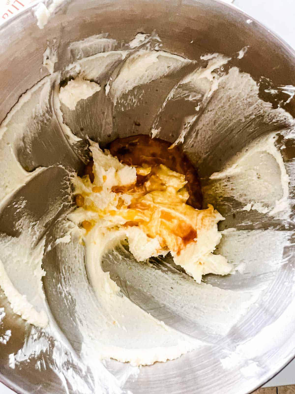 Photo of butter, sugar, egg, and vanilla in the bowl of a stand mixer.