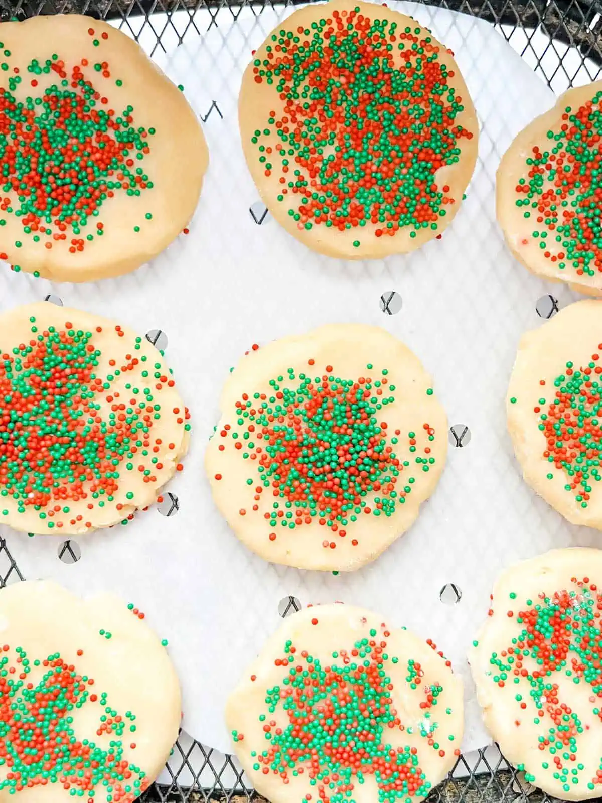 Photo of sugar cookies in an air fryer basket ready to cook.