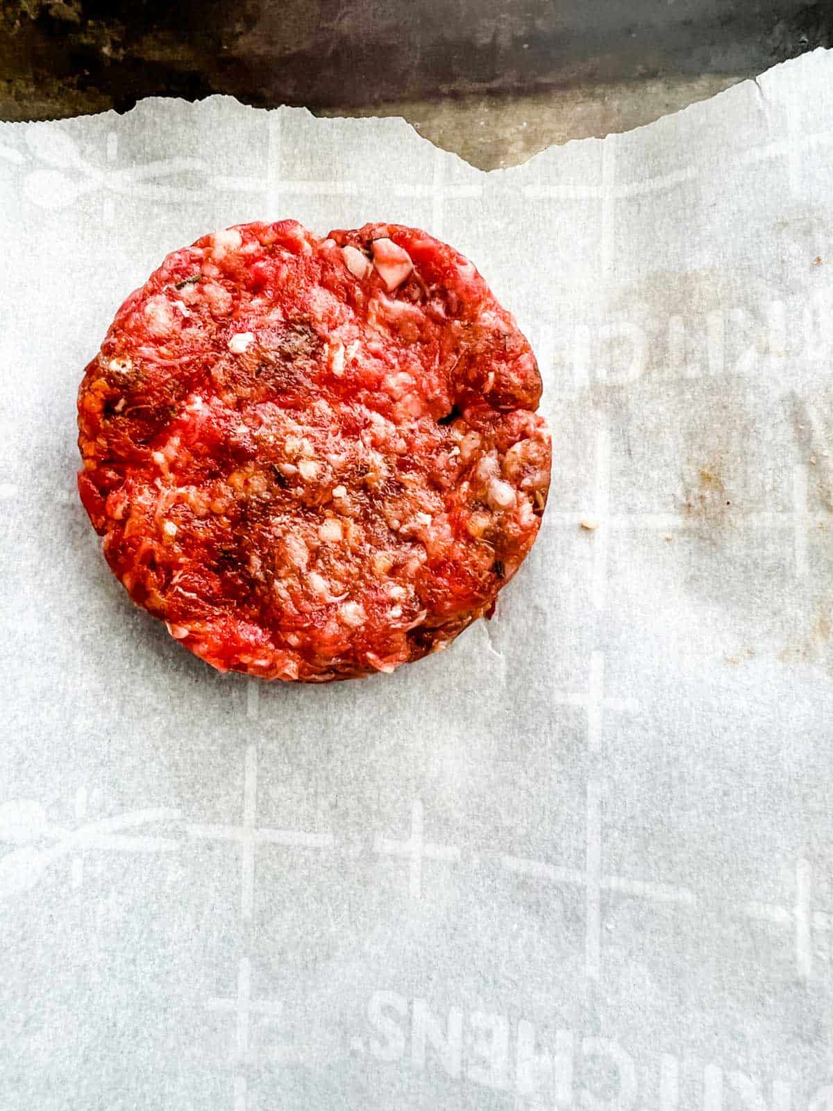 Close up photo of a formed sausage patty.