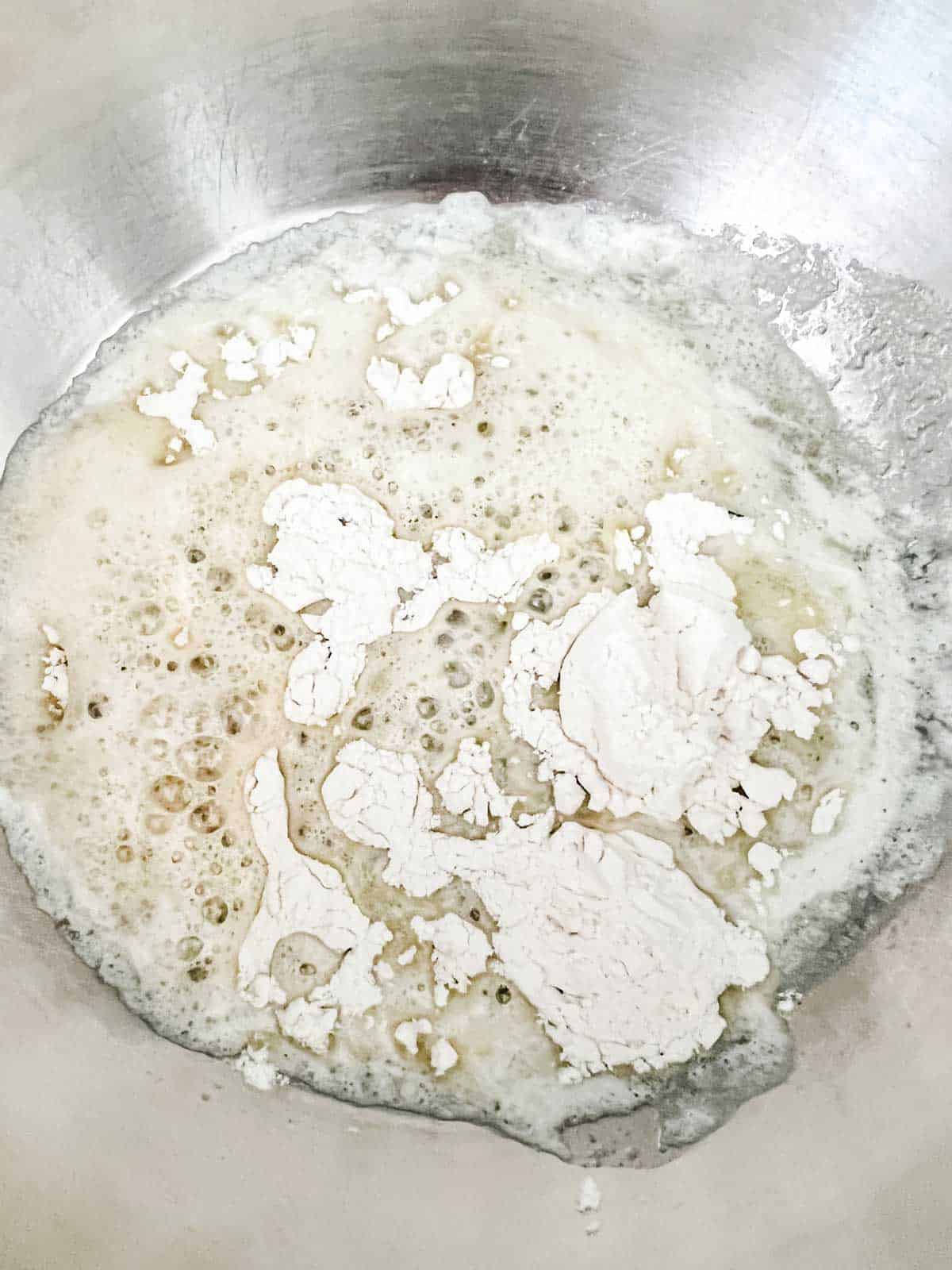 Photo of melted butter that has had flour sprinkled on it in a skillet.