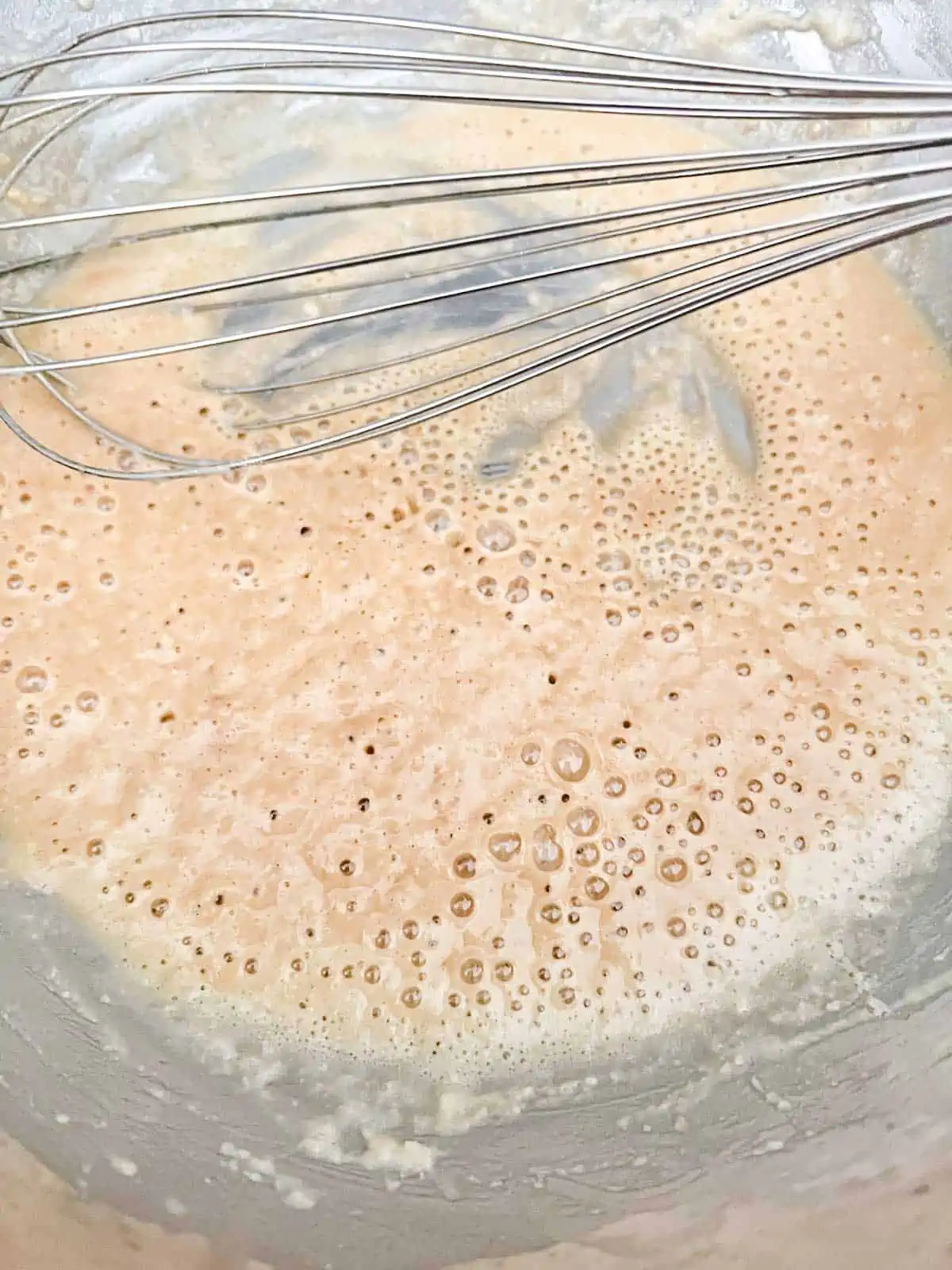 Photo of a roux being whisked in a skillet.