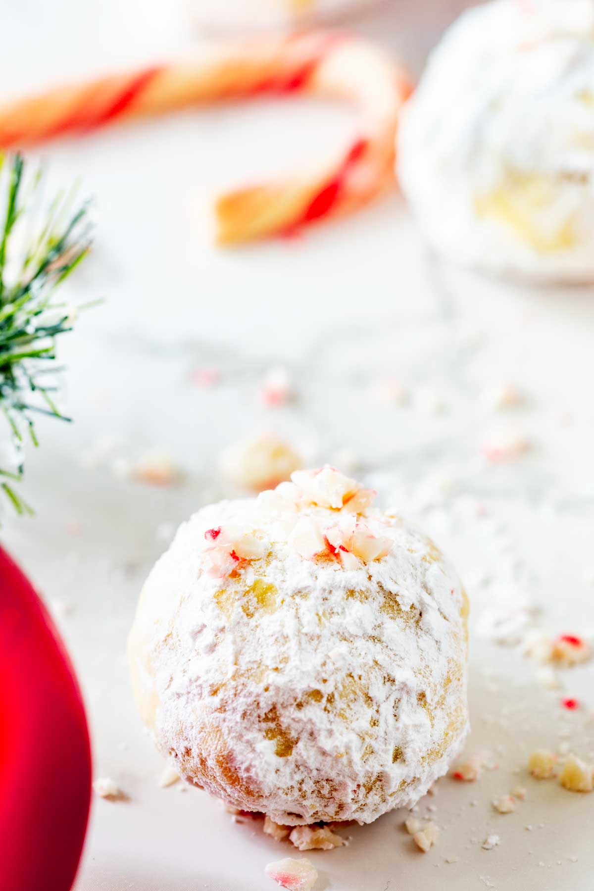 Side close up photo of a peppermint snowball cookie.