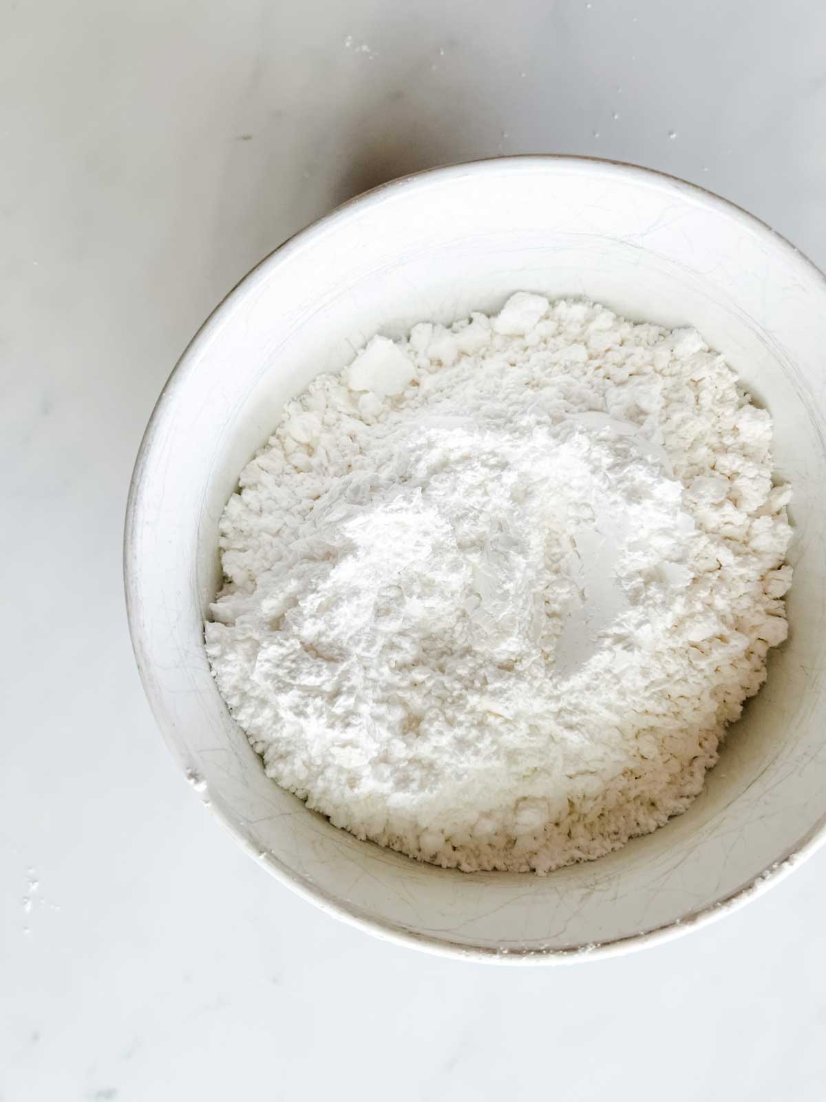 Powdered sugar in a white bowl.